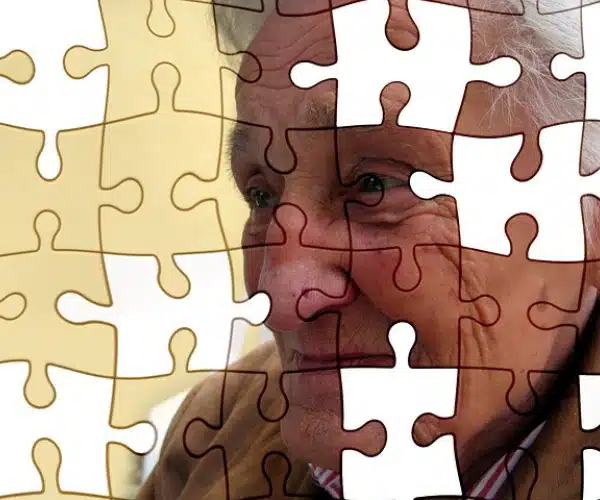 Portrait d’une personne âgée superposé à un motif de puzzle, symbolisant la mémoire et la stimulation cognitive en maison de retraite